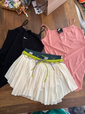Nike Pink & Black bodysuit with Cream Pleated Skirt and Green Accents